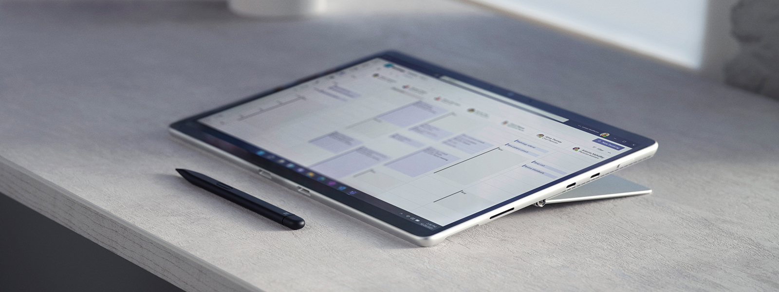 Surface Pro sitting on a granite desktop with a stylist pen.