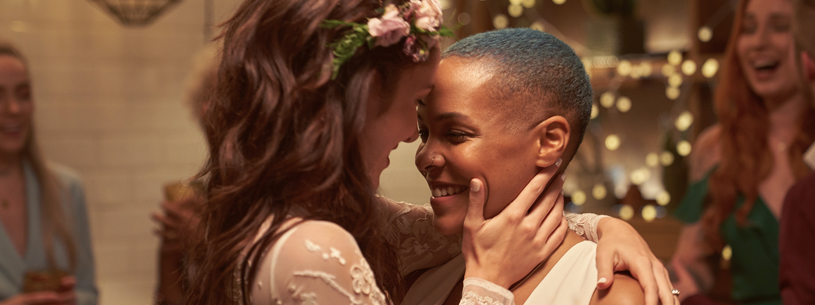 Two just married women having their first dance at the wedding party .