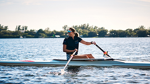 Anna Mclean out on the water rowing in a racing shell