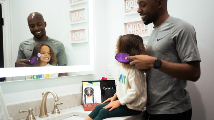 A Father Learning How to Do His Daughter's Hair from a Microsoft Surface Tablet