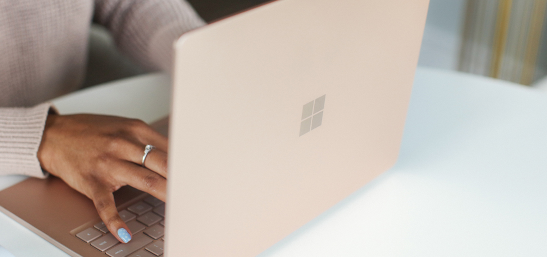 A close up view of someone typing an essay on their Surface laptop.
