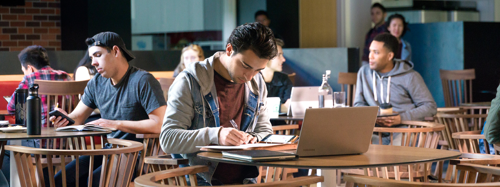 A group of students studying in a café preparing for an essay.