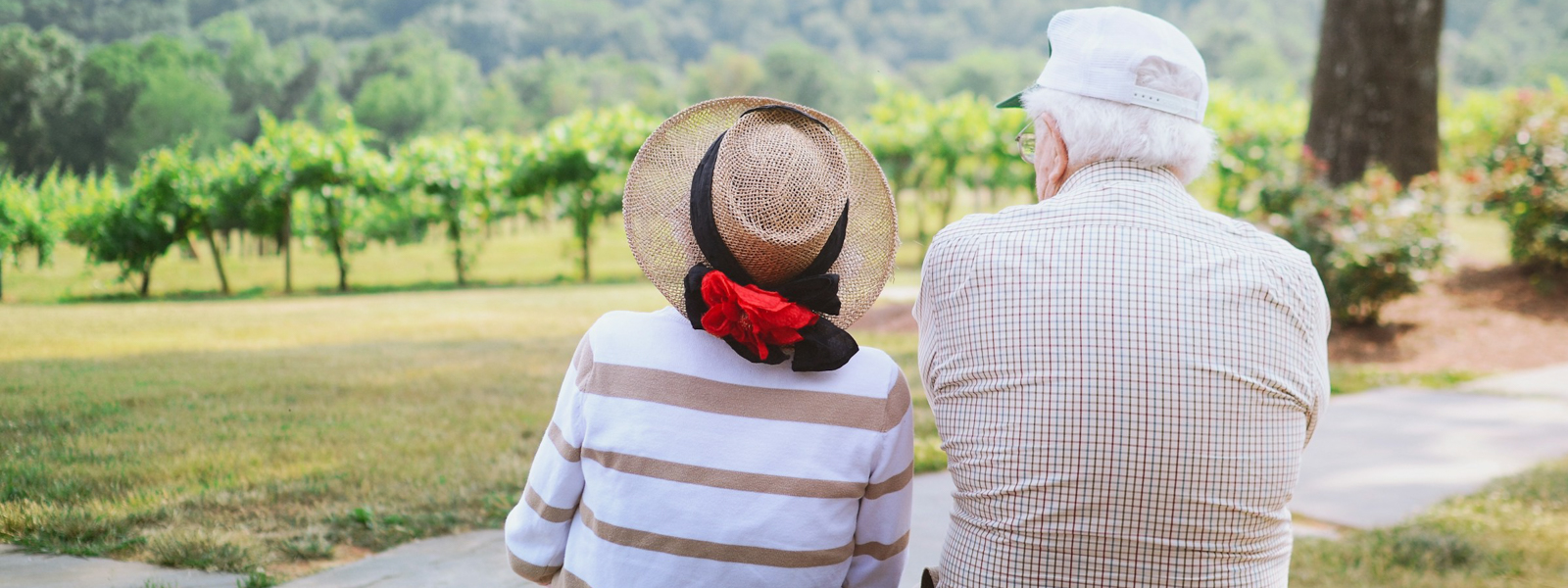 An elderly couple sitting outside