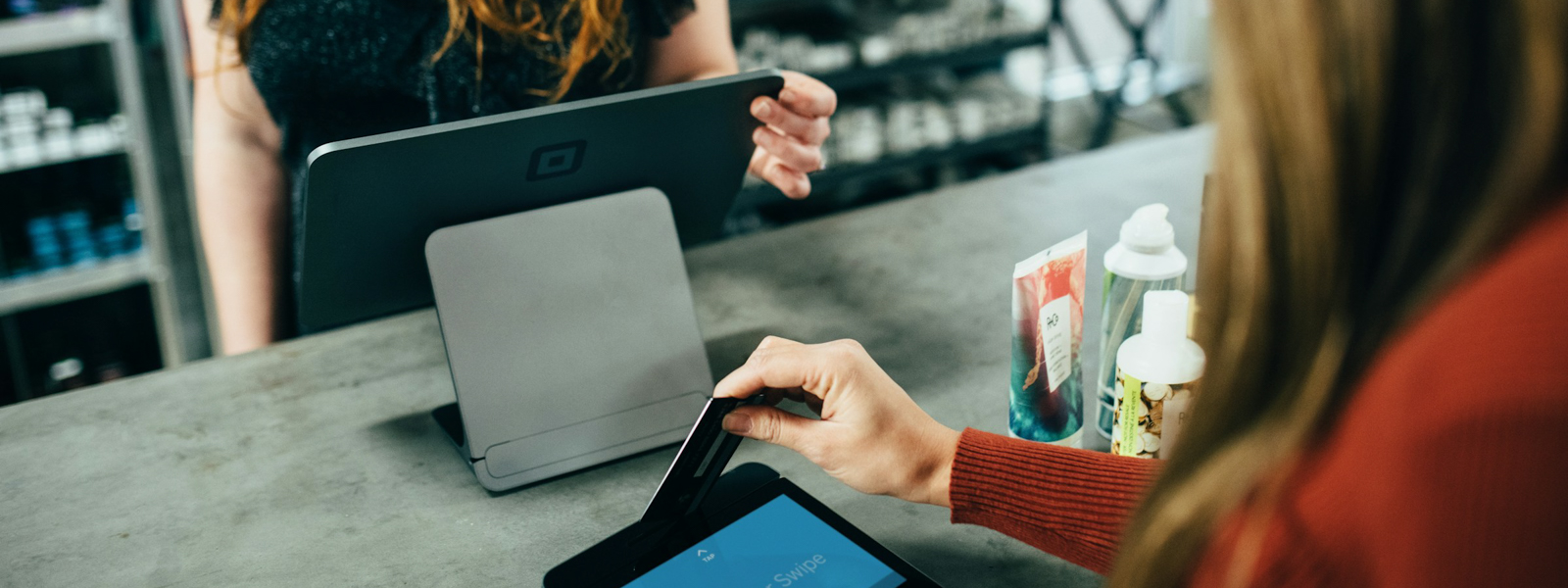 Woman making a purchase at a store with her credit care