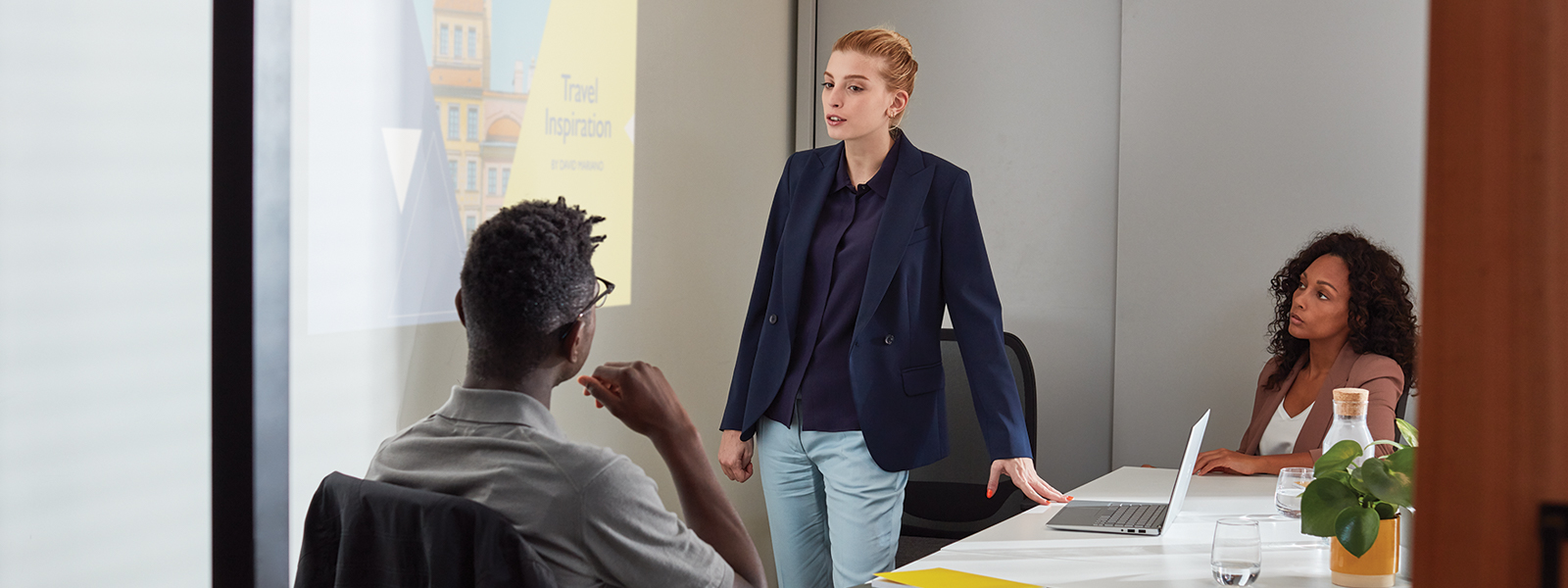 a young adult student presenting in PowerPoint on Dell Inspiron 7000.