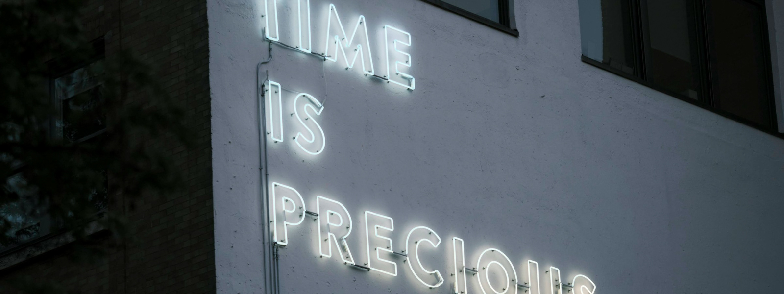Building sign that says time is precious