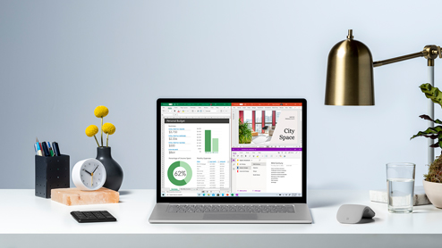 Contextual image of Surface Laptop 4 Platinum inside alone on desk with Excel, PowerPoint and OneNote snapped on screen